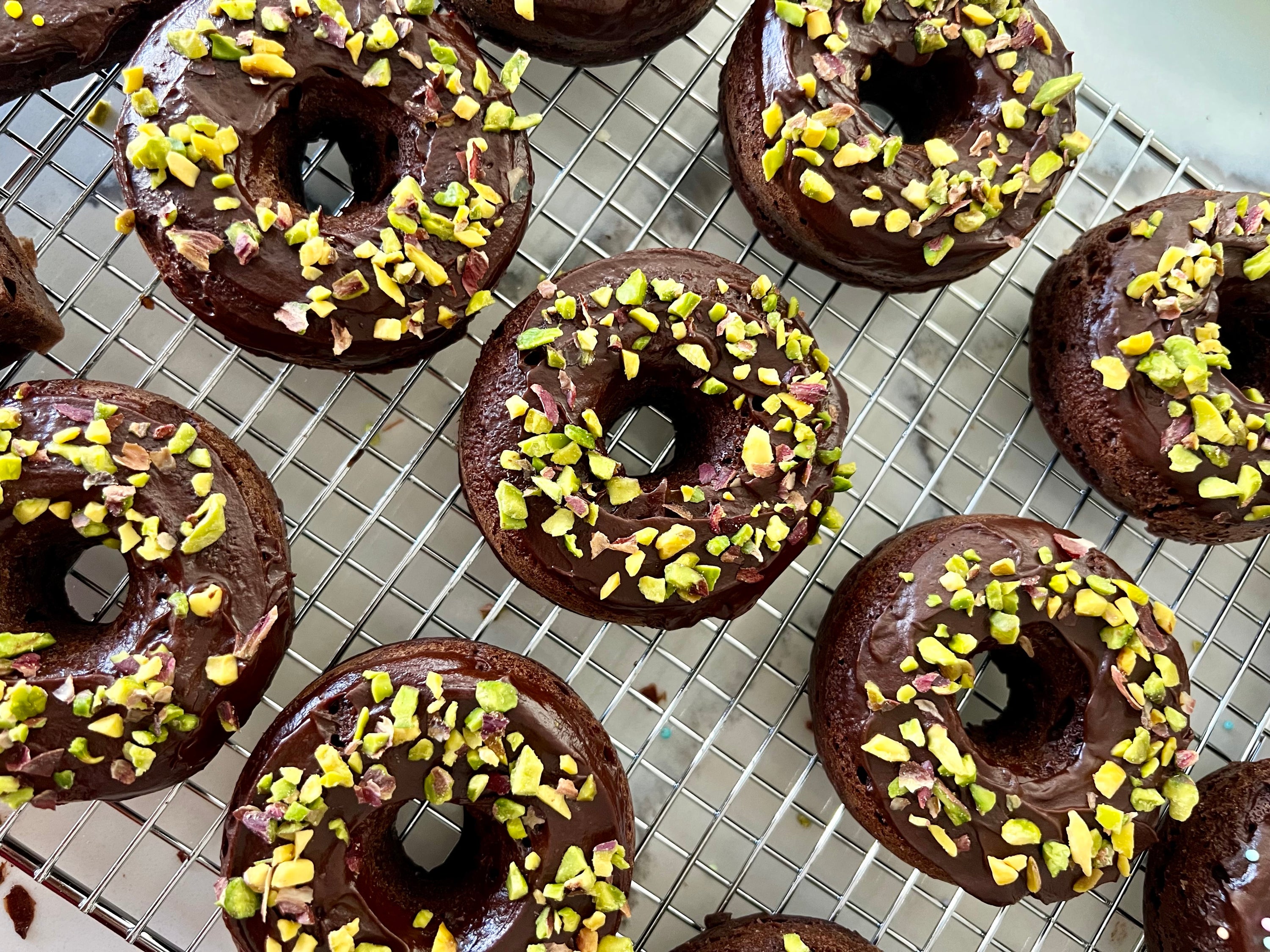 gluten-free baked pistachio chocolate donuts, featuring rich chocolate donuts topped with crushed pistachios, showcasing a delicious and healthy breakfast treat