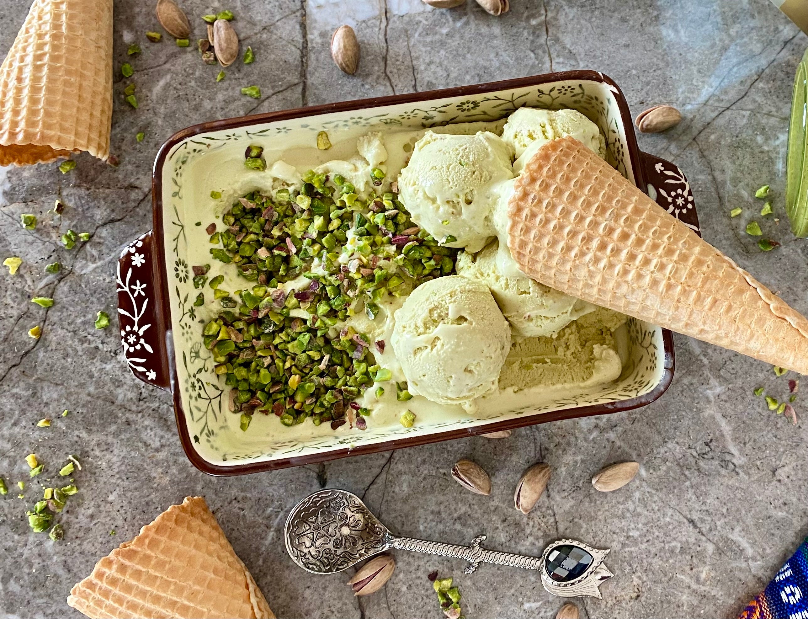 creamy pistachio ice cream or gelato in a bowl, garnished with chopped pistachios, showcasing its rich green color and smooth texture