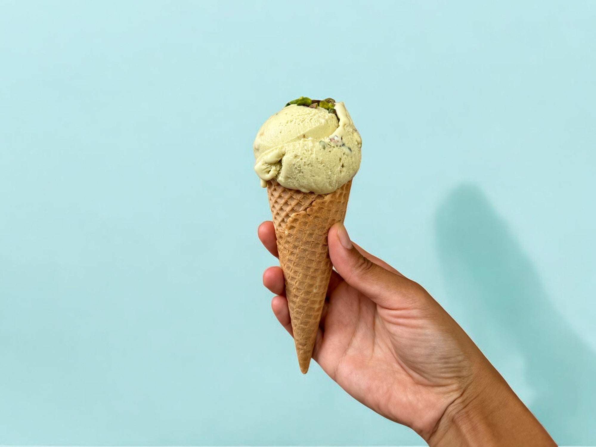 pistachio ice cream, pistachio creami, pistachio ninja creami, ninja creami pistachio ice cream topped with chopped pistachios