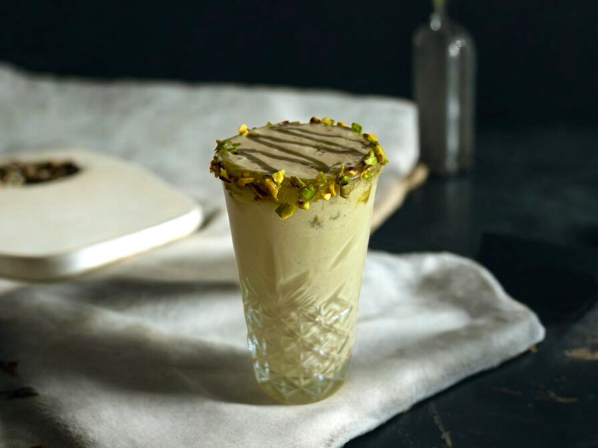 pistachio protein shake with pistachio butter, pistachio cream and protein powder, pistachio protein shake with pistachio butter drizzled on top