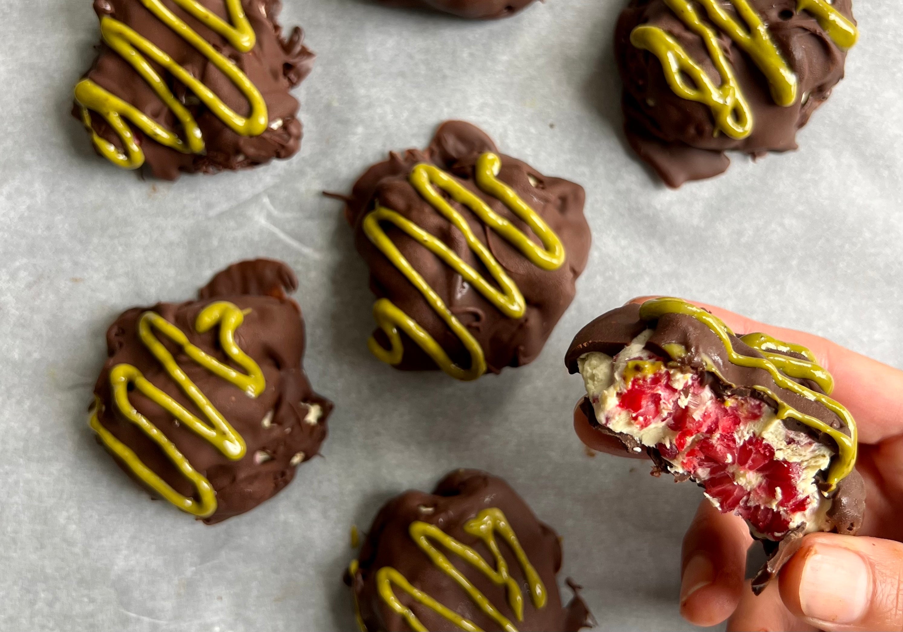 pistachio raspberry yogurt clusters coated in chocolate, featuring tangy yogurt, sweet raspberries, crunchy pistachios, and a rich chocolate shell for a delightful treat