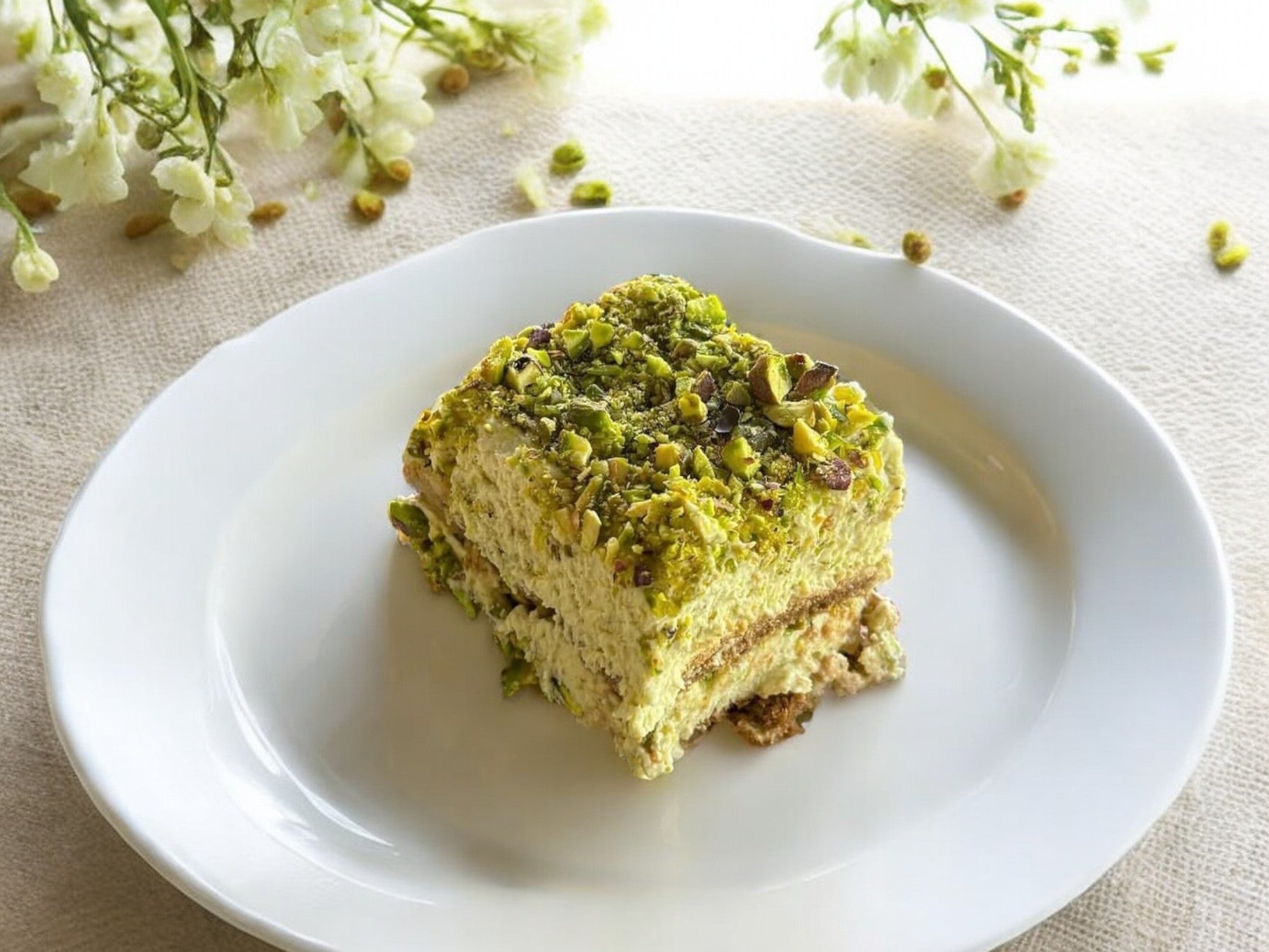 pistachio tiramisu with pistachio cream and chopped pistachios on top