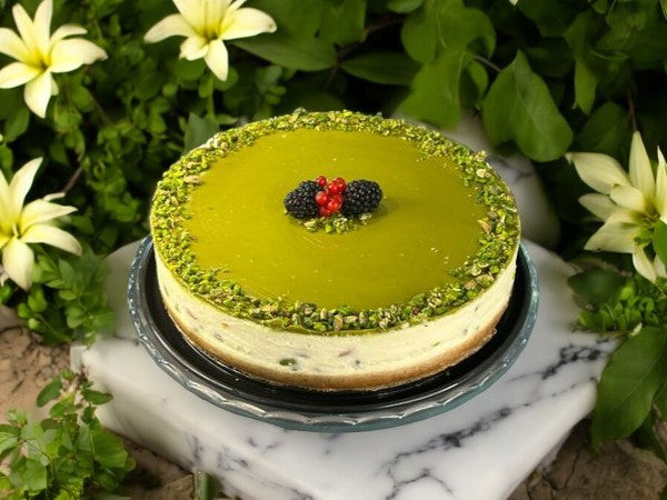 decadent pistachio cheesecake topped with a layer of smooth pistachio cream, featuring a buttery crust and garnished with chopped pistachios for an irresistible dessert